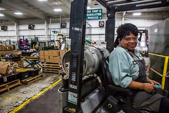 Woman driving a forklift in a factory