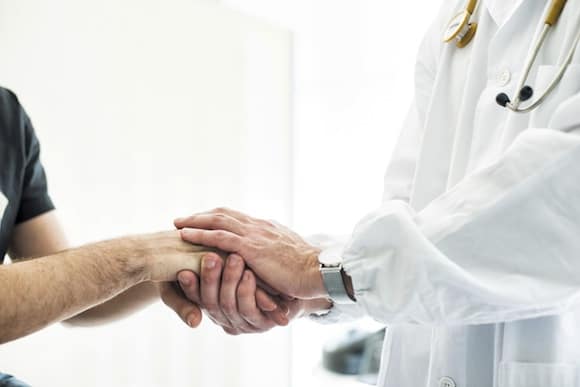 Doctor and patient shake hands
