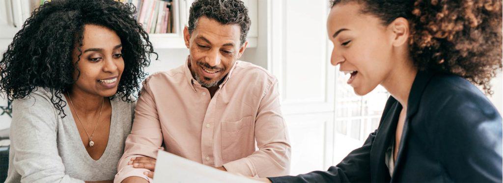 Man and woman reviewing insurance papers with their provider