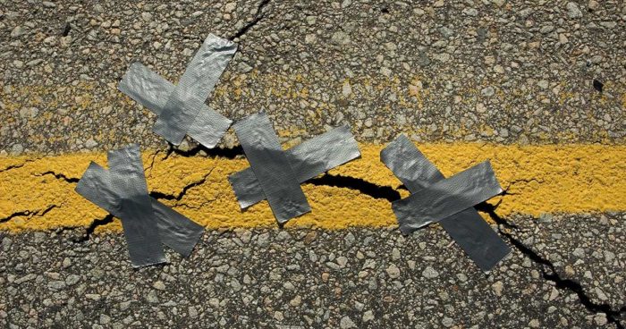 Duct tape being used to patch cracks in pavement